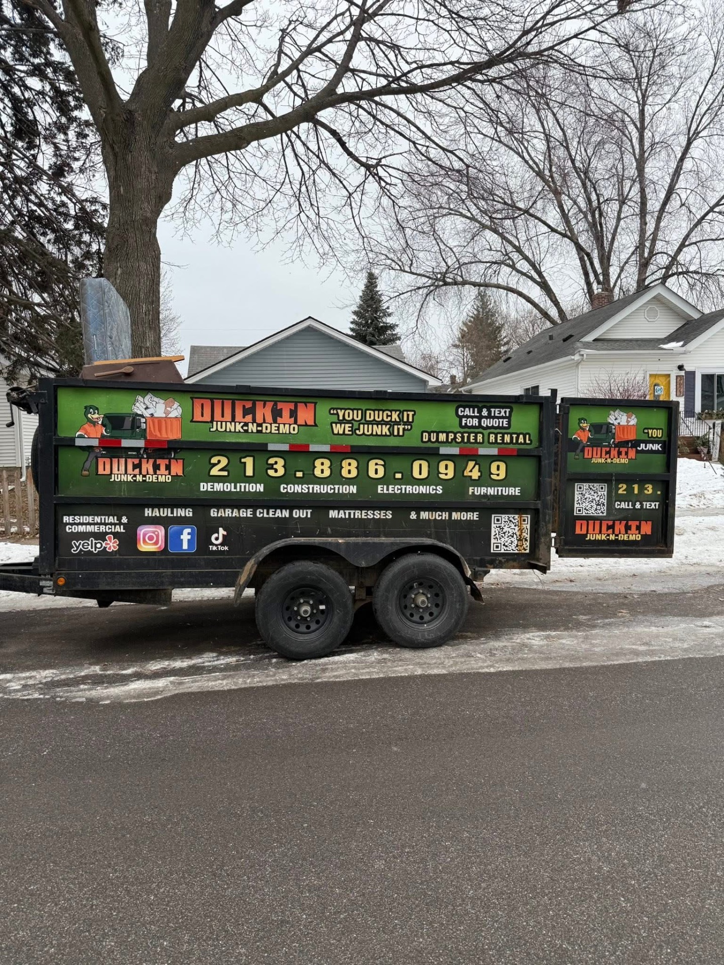 Duckin Junk-N-Demo dumpster trailer on a Minneapolis street